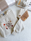 Fall sweater featuring cozy autumn-themed design, perfect for the season.
