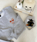 Fall Sweaters featuring a unisex sweater with Halloween designs, perfect for cozy autumn looks.