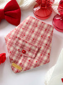 Dog Bandana - In Your Heart featuring a pink plaid pattern with red hearts and a button, perfect for stylish pups.